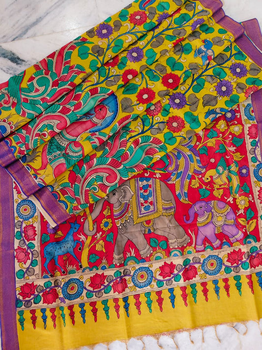 Colorful fabric with elephant and floral patterns on a yellow background