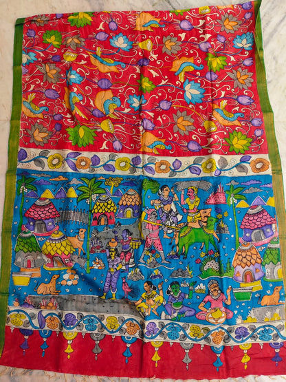 Colorful traditional fabric with intricate patterns and characters on a red and blue background.